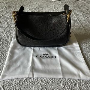 Coach Cary shoulder bag in black with gold hardware.